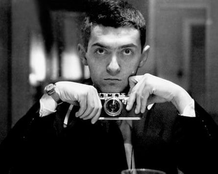 A black-and-white shot of a young Stanley Kubrick holding a camera